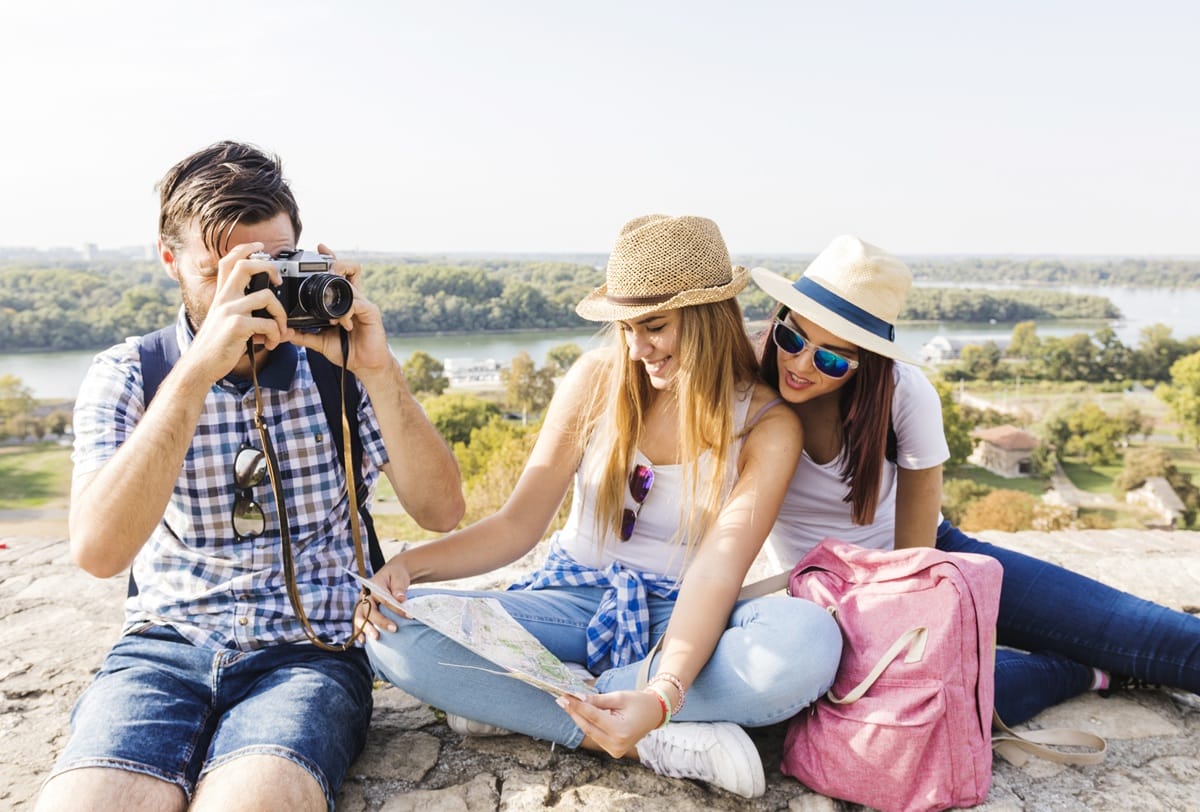 Friends using a map while sightseeing in Western Australia, planning accessible travel with a WA Companion Card